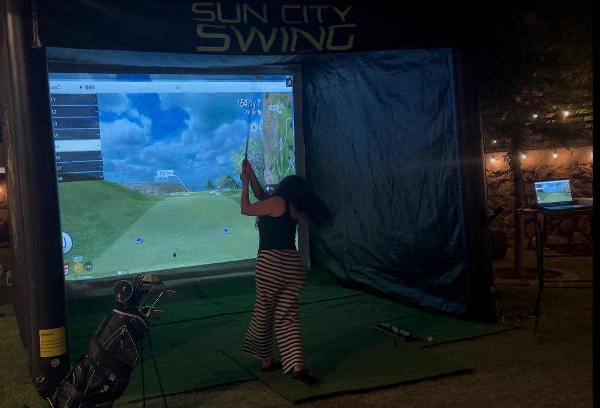 Simulator set up at a backyard event under string lights
